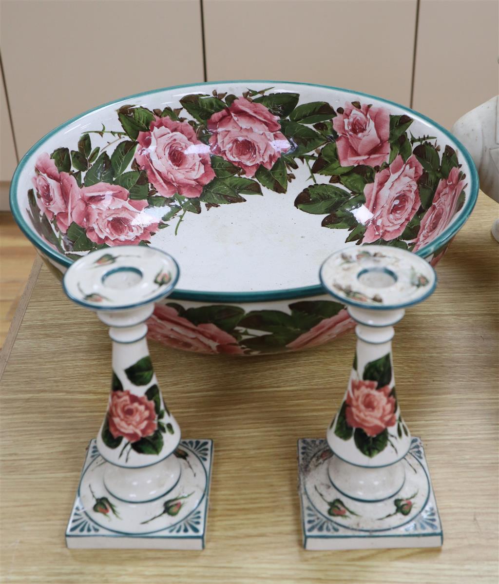 A Wemyss pottery Cabbage rose decorated toilet bowl, diameter 39cm, and a pair of Weymss style candlesticks by Griselda Hill pottery